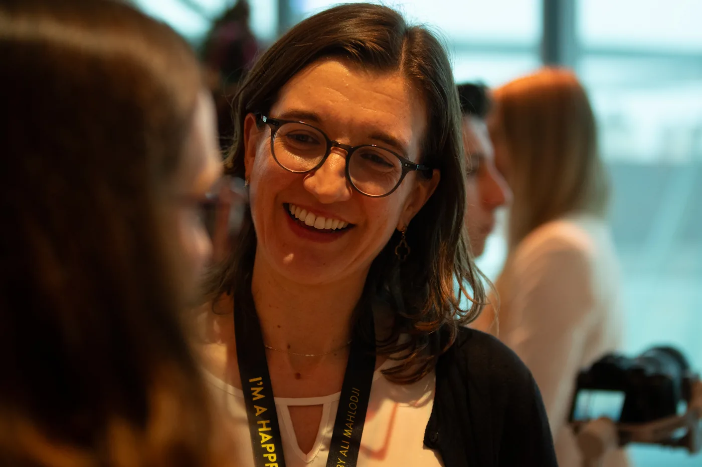 A participant with glasses laughing in conversation
